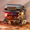 A detailed wooden miniature dollhouse kit of a Japanese restaurant featuring a tiled roof and an open storefront.