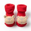 Pair of red baby anti-slip cotton socks with festive Christmas bear designs