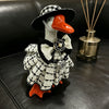 A handcrafted mini goose statue dressed in a black and white plaid outfit with a bow and pearl details.