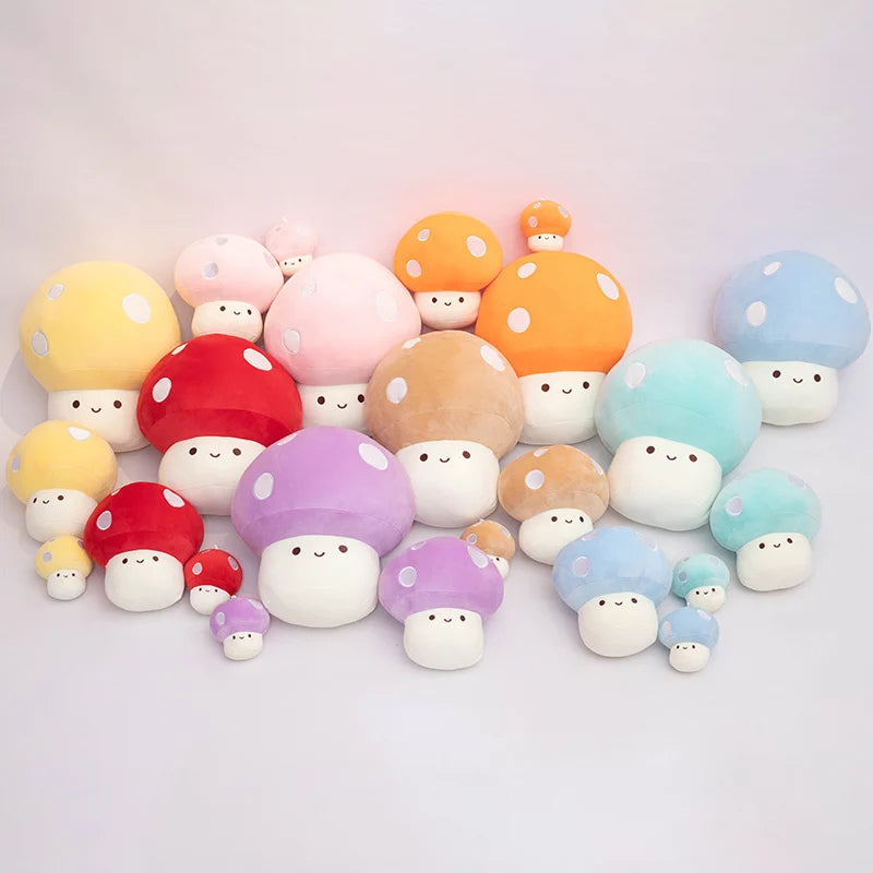 A collection of soft, colorful mushroom plush pillows in various shades including yellow, pink, orange, and blue.