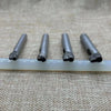 A set of five precision leather hole punches with metal tips resting on a white plastic rod.