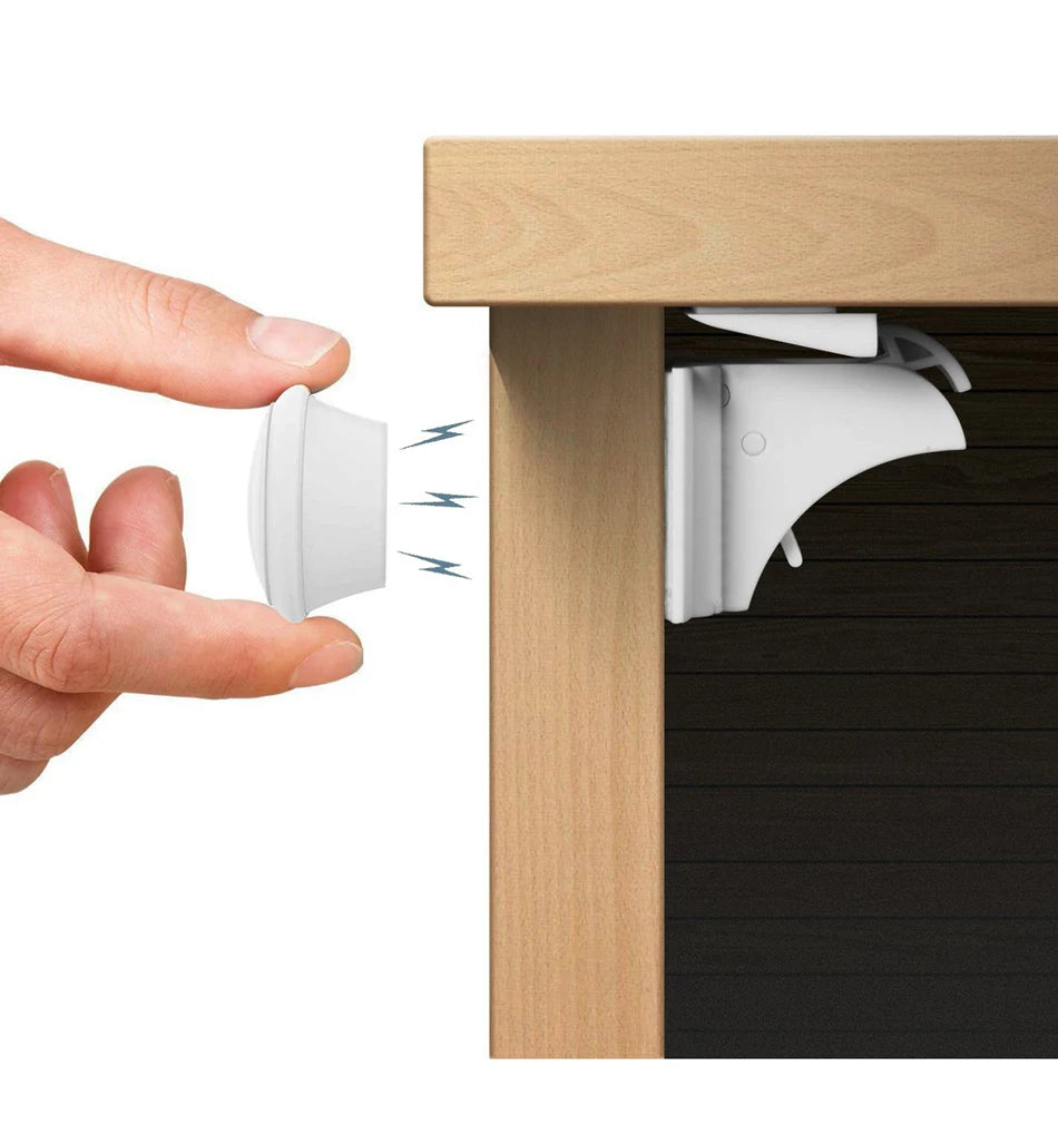 A hand is shown inserting a magnetic child safety lock into a cabinet, demonstrating the no-drilling installation method.