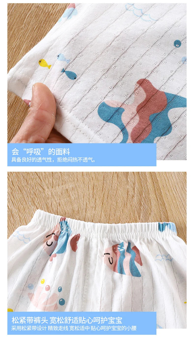 Close-up of a white cotton pajama fabric with light pastel designs and a hand touching the material.