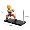 A figurine of Son Goku performing a Kamehameha pose, mounted on a black base with an LED light.