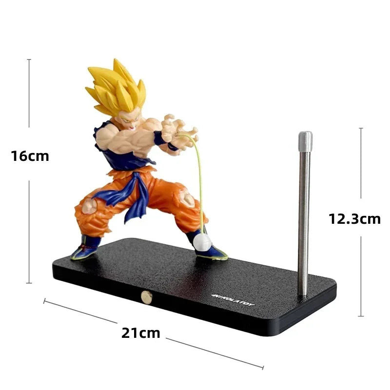 A figurine of Son Goku performing a Kamehameha pose, mounted on a black base with an LED light.