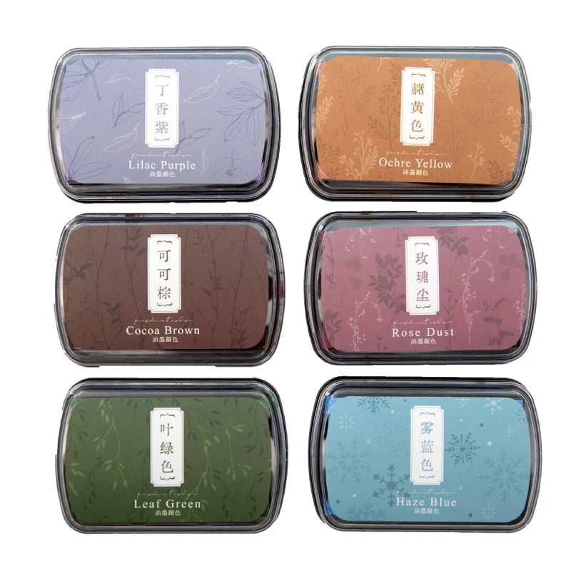 A set of six vintage craft oil-based ink pads in various colors including Lilac Purple, Ochre Yellow, Cocoa Brown, Rose Dust,