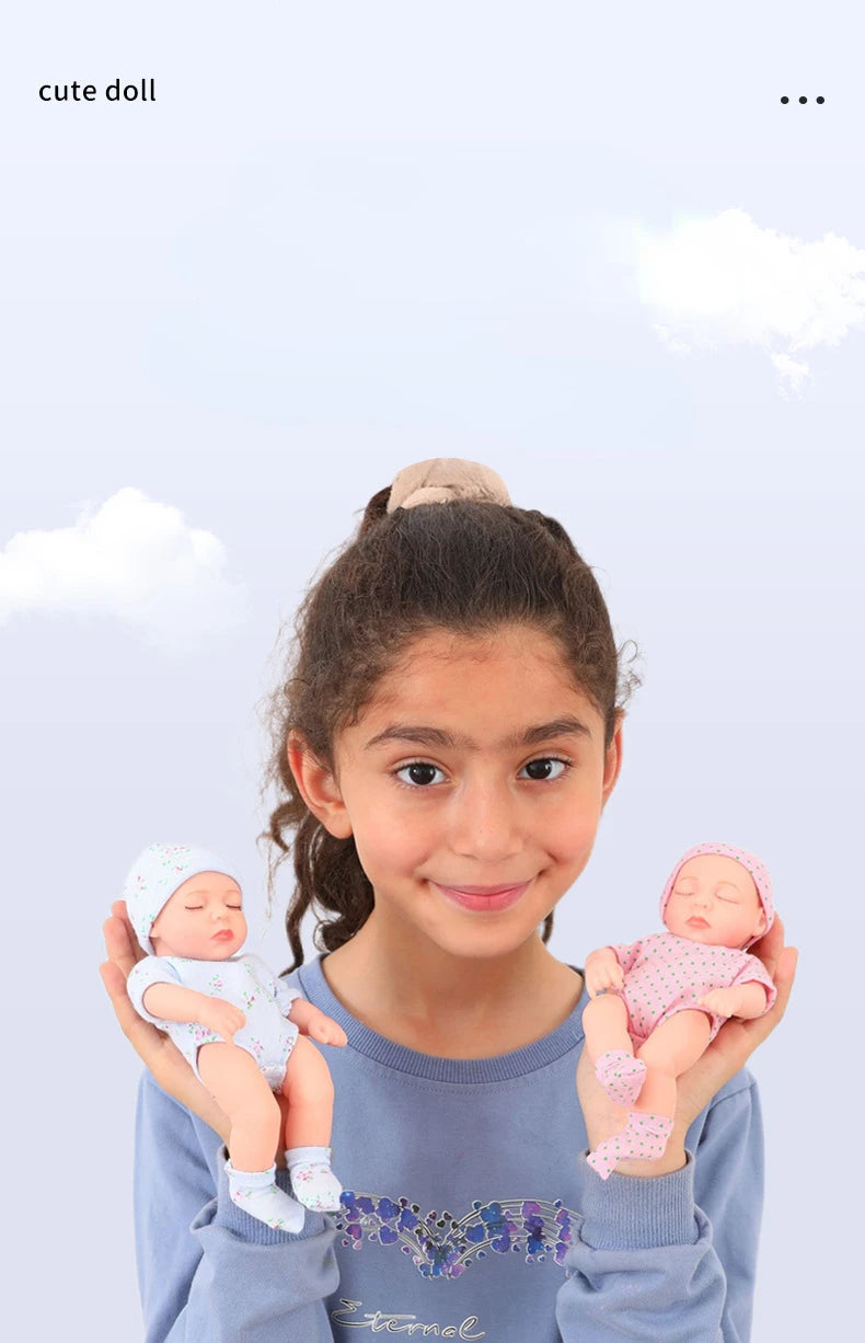 A girl holds two realistic soft vinyl baby dolls with newborn outfits.