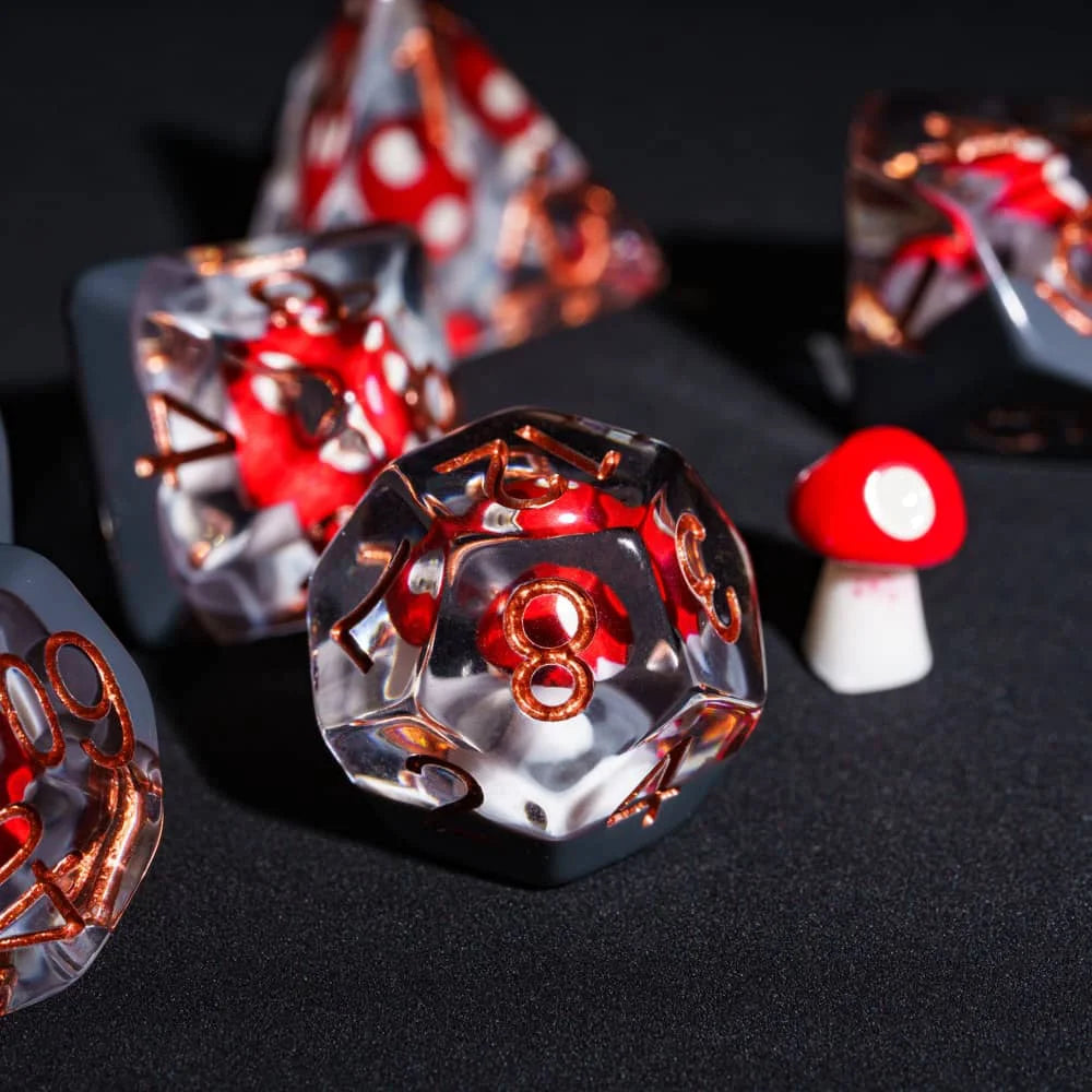 A close-up of a set of polyhedral dice featuring a mushroom theme with red and gold accents.