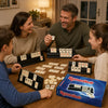 A family plays with a box of Classic Rummikub tiles on a wooden table.
