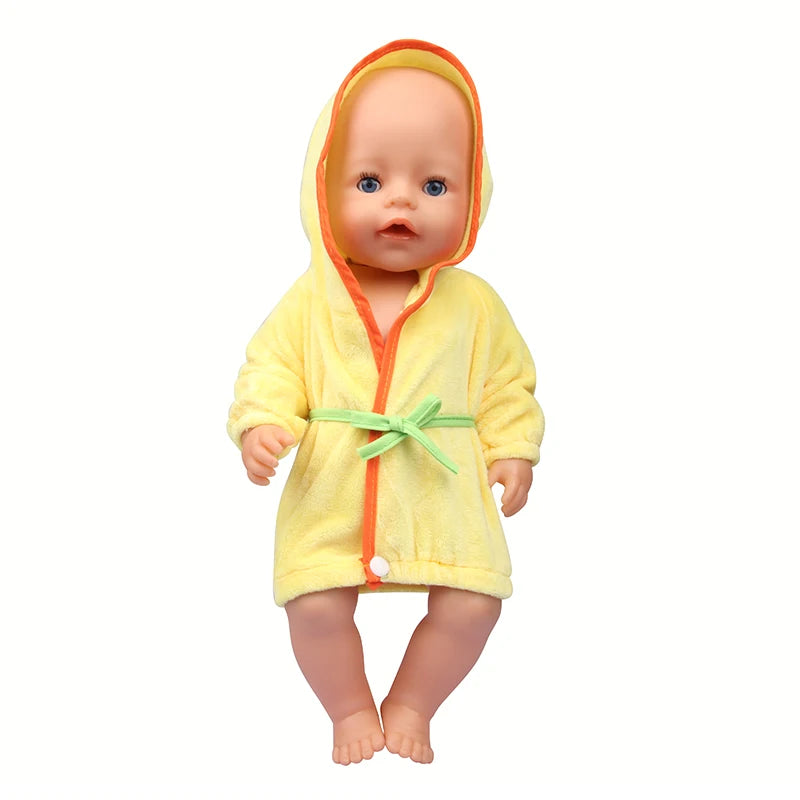 A baby doll wearing a yellow hooded bathrobe with orange trim and a green tie.