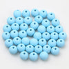 A collection of light blue matte acrylic beads shaped like macarons for jewelry making