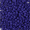 A close-up view of a pack of small, round, purple pony beads for jewelry making and craft projects.
