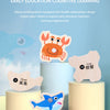 Two wooden magnetic sea creatures, a crab and a shark, are displayed on light-colored cylindrical bases.
