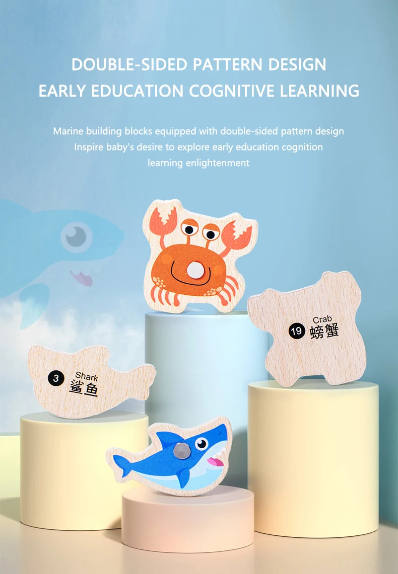 Two wooden magnetic sea creatures, a crab and a shark, are displayed on light-colored cylindrical bases.