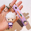A small white and purple anime character resin keychain with a gold split ring attached to a purple tag.