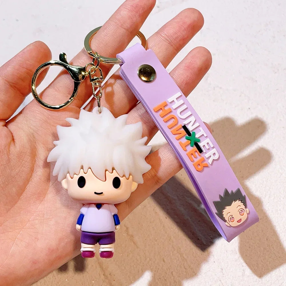 A small white and purple anime character resin keychain with a gold split ring attached to a purple tag.