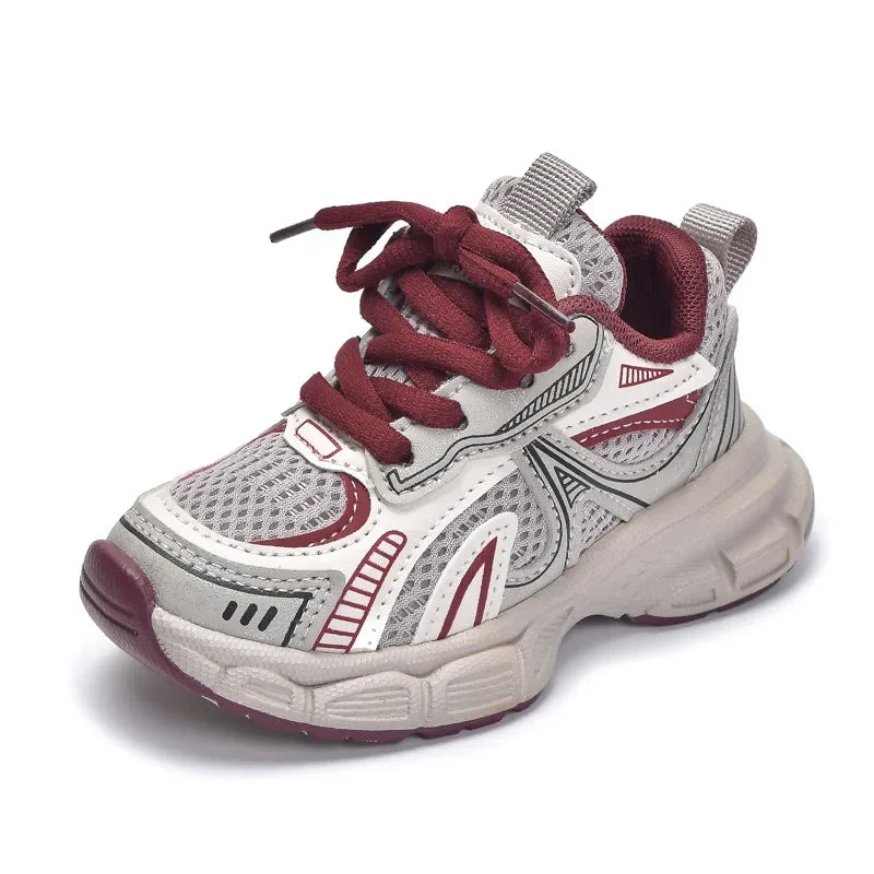 A pair of red and gray breathable mesh kids running sneakers with a cushioned sole.