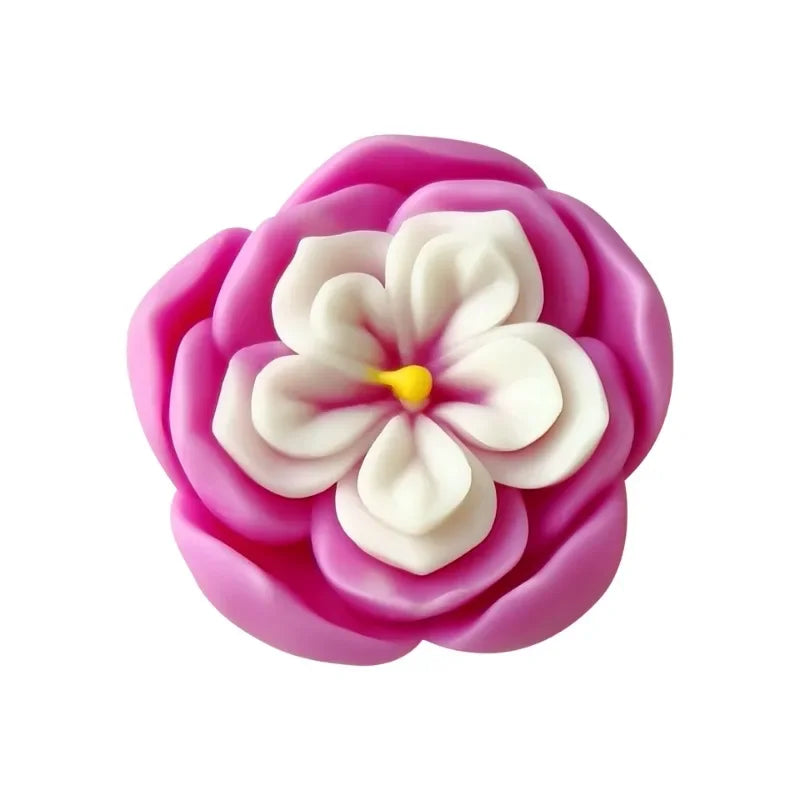 A pink rose flower silicone mold with white petals used for candle and soap making.