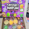 A box of a mystery dumpling countdown calendar containing various squishy toys and fidget items.