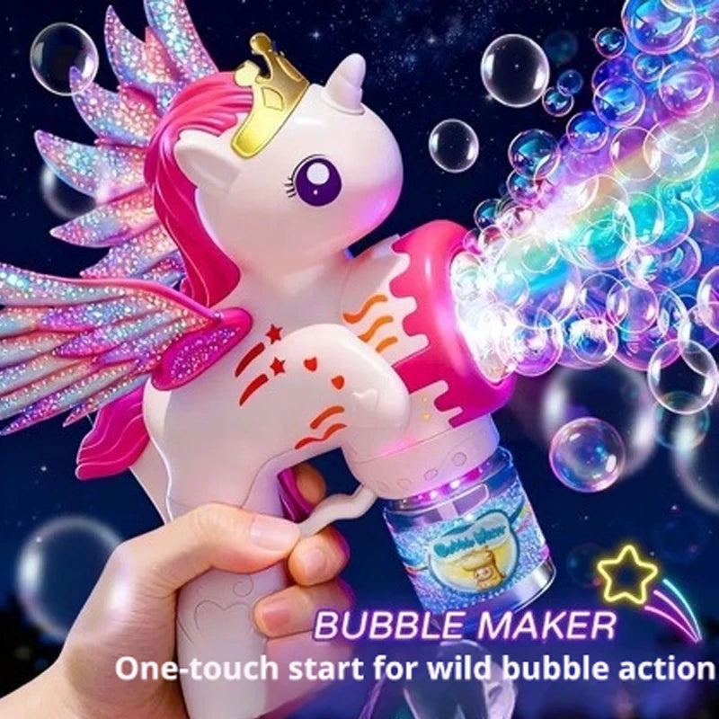 A hand holds a pink unicorn toy bubble maker with colorful lights and sparkling wings against a dark background.