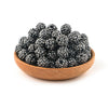 A wooden bowl filled with dark, glittering rhinestone resin bayberry ball beads for jewelry making