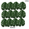 Twelve artificial tropical palm leaves in dark green color displayed on a white background.