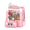A pink mini claw machine toy for kids featuring a rabbit design and various plush toys inside.