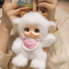 A fluffy white plush pendant featuring a cute animal face design, held by a person.