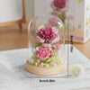 A clear glass jar contains a DIY flower bouquet building blocks set with pink and green flowers.