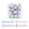 A collection of soft silicone beads in various pastel shades including blue, pink, and gray, displayed in a clear container.