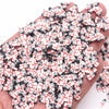 A pile of small polymer clay slices in black and white with red accents for DIY crafts