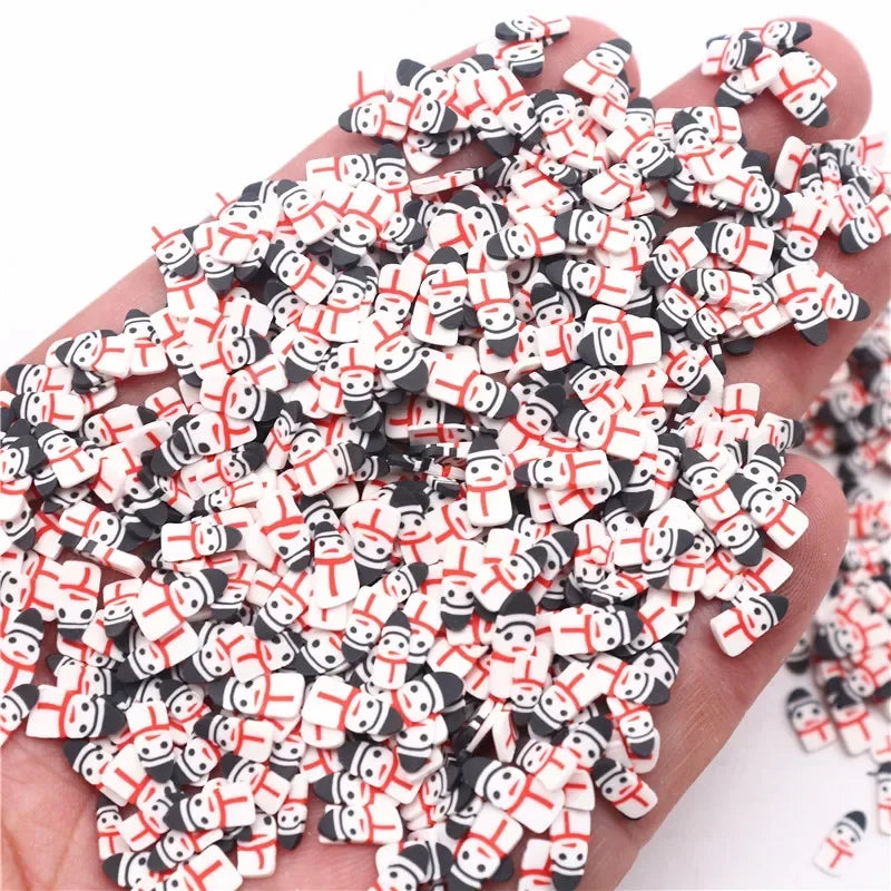 A pile of small polymer clay slices in black and white with red accents for DIY crafts
