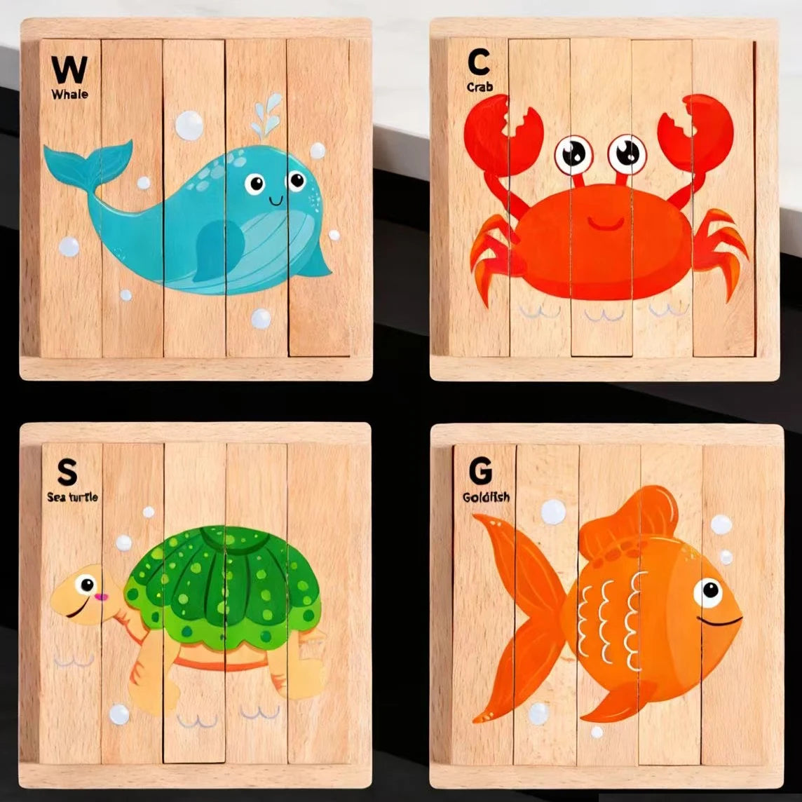Four wooden jigsaw puzzles featuring sea animals: whale, crab, sea turtle, and goldfish.