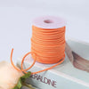 A roll of orange velvet faux suede braided ribbon for crafting and gift wrapping