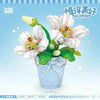 A floral bouquet building block set featuring white and pink flowers in a blue pot.