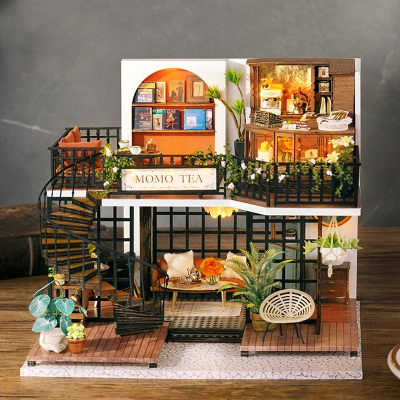 A detailed miniature dollhouse puzzle kit featuring a multi-story wooden structure with interior details and landscaping.