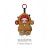 A cute, round figure of a brown bear with red hair and large eyes, packaged as a mystery box collectible.