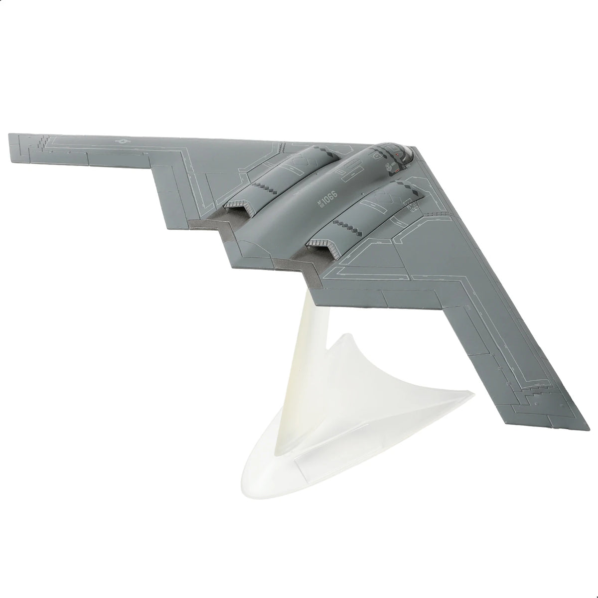 A gray diecast model of a B-2A Spirit stealth bomber with an accompanying display stand.