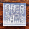 A clear silicone mold featuring various intricate nail art designs including sea shell, starfish, and ocean themes.