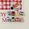 A set of eight kawaii jam jar fridge magnets featuring various food items and colorful designs.