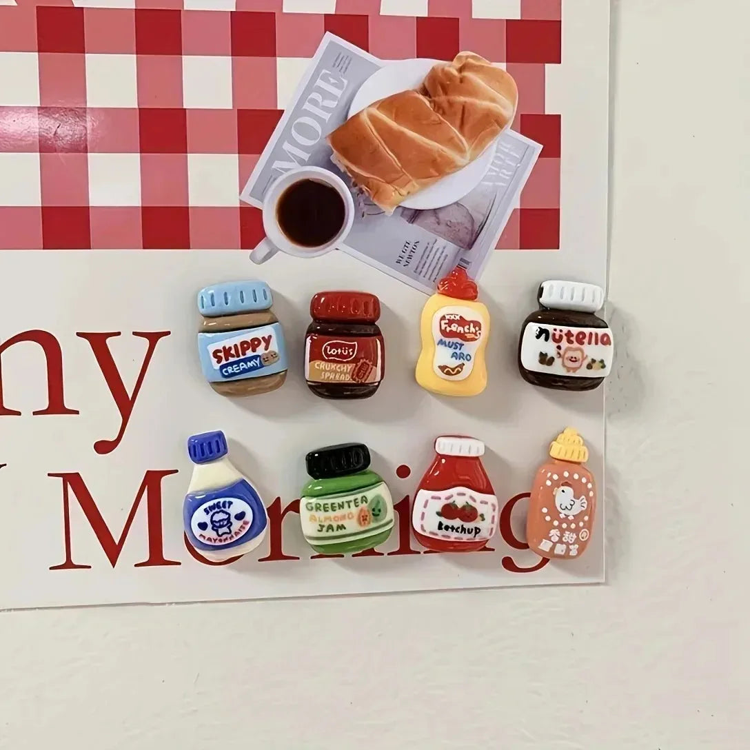 A set of eight kawaii jam jar fridge magnets featuring various food items and colorful designs.