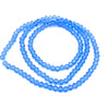 A strand of light blue faceted crystal beads coiled in a circular shape for jewelry making