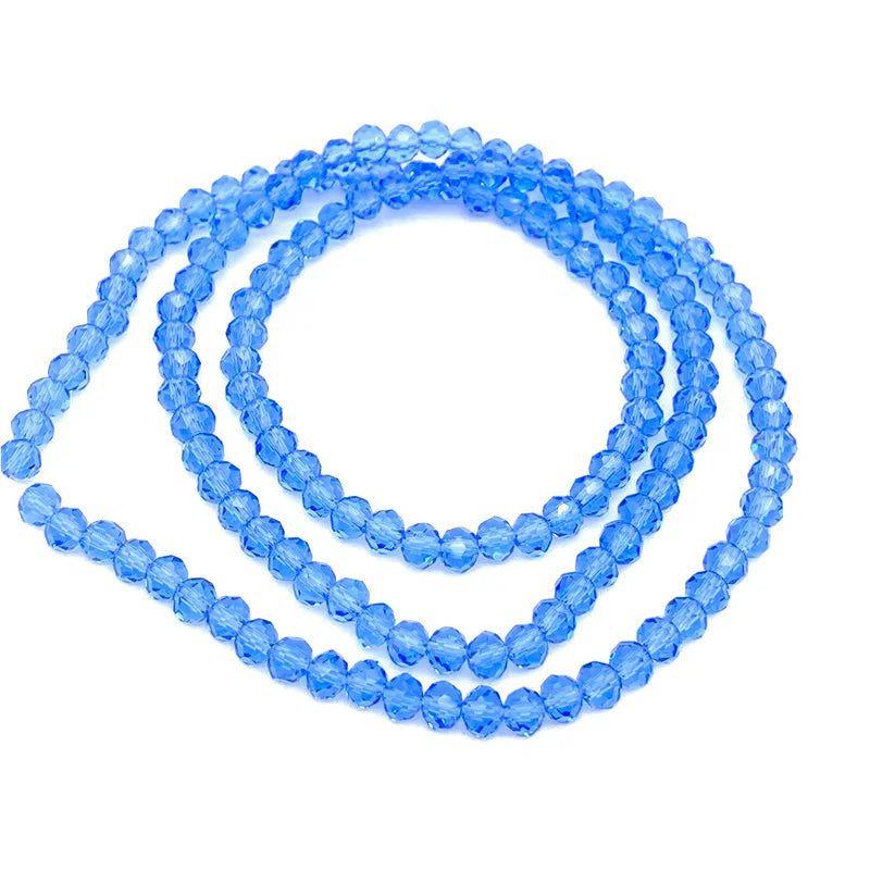 A strand of light blue faceted crystal beads coiled in a circular shape for jewelry making