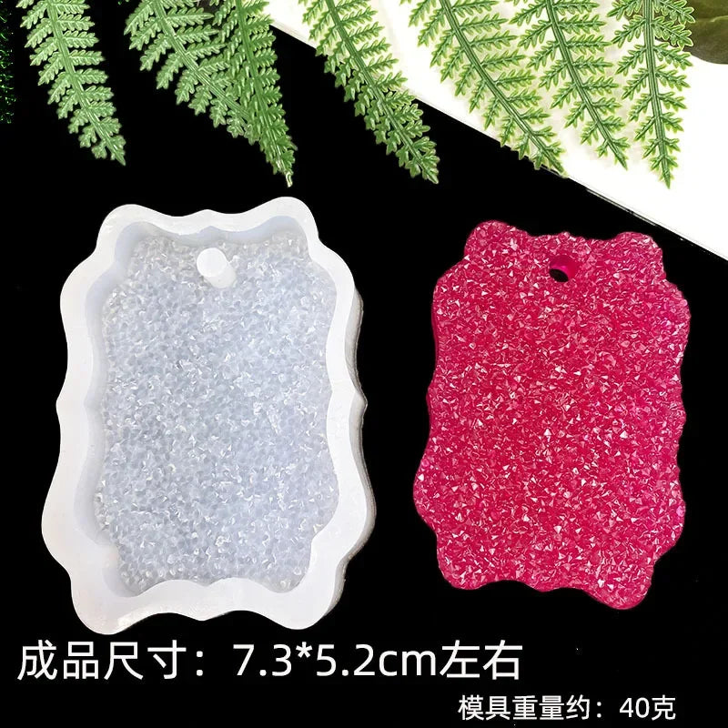 A set of flexible silicone resin molds in white and pink, including heart, round, oval, and rectangle shapes.