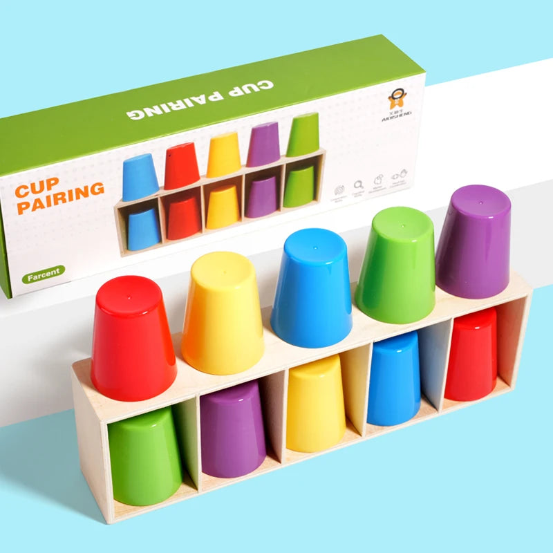 A box of cup pairing toys showing various colored cups arranged in compartments for preschool learning.