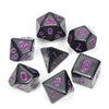 A collection of black acrylic dice showing various numbers and shapes for tabletop role-playing games