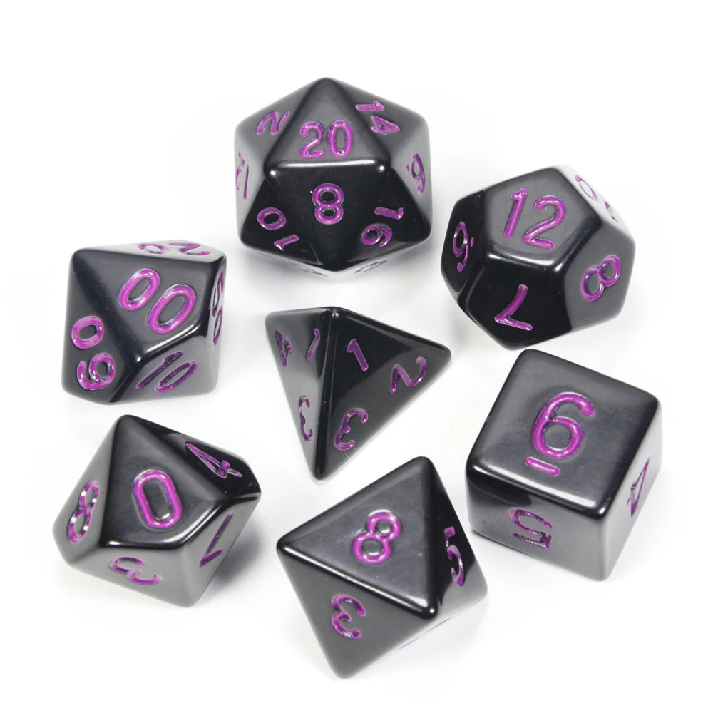 A collection of black acrylic dice showing various numbers and shapes for tabletop role-playing games
