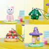 A set of polymer clay figures, including a white rabbit, a green frog, and a purple mushroom house, with carving tools.