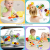 A set of three suction cup spinner bath toys for babies, including a yellow bowl, orange and green toys, and a round toy.