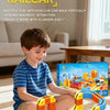 A young boy is playing with a yellow and orange magnetic modular system train set on a carpet.
